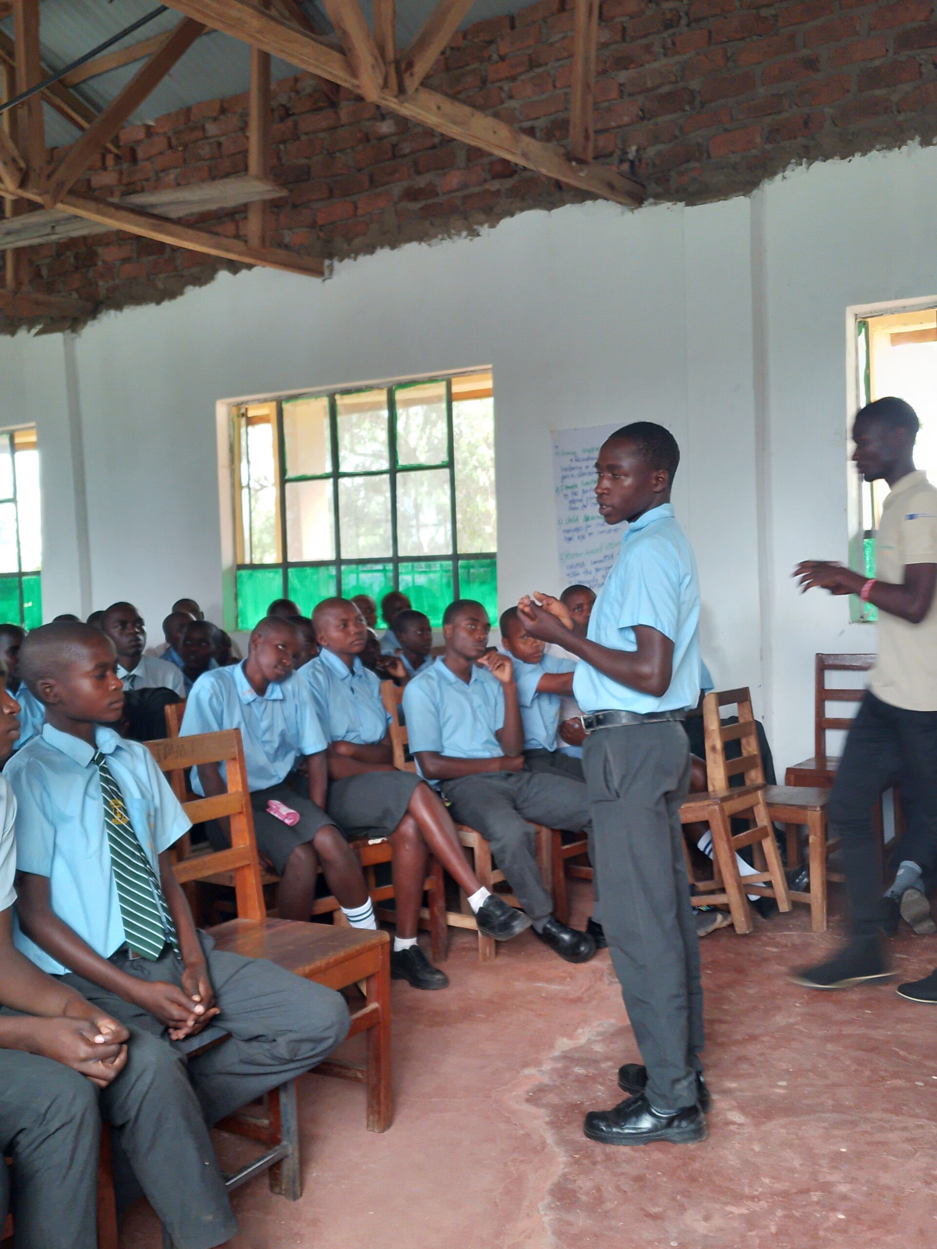 St. Luke Ekware Secondary School - The EU-funded grassroots initiative began with an interactive workshop at St. Luke Ekware Secondary School in Nyamasibi, Kisii County. Titled "Gaki Tegerera!" (a Kisii phrase for "please listen"), this workshop was the first of four activities designed to create awareness about GBV. The students actively engaged in discussions about various forms of GBV, sharing their experiences and exploring ways to recognize and prevent abusive behaviors. The workshop provided a safe space for students to express their thoughts and learn about the importance of respectful relationships. Photos from the event capture the intensity of the discussions and the passion of the participants, such as students in a circle discussion and a student presenting their perspective on GBV.